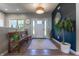 Bright entryway with wooden floors, a rug, modern mirror, and a charming wooden bench at 1472 Maple Ridge Ct, Columbus, IN 47201