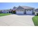 Wide driveway leading to a two-car garage on a single story home at 1472 Maple Ridge Ct, Columbus, IN 47201