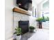 Close-up of a stone fireplace with a wooden mantel and a mounted TV above at 1472 Maple Ridge Ct, Columbus, IN 47201