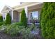 Charming front porch with stone accents, complemented by manicured landscaping and a tranquil water feature at 1472 Maple Ridge Ct, Columbus, IN 47201