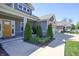 Charming front porch with cozy seating, stone accents, and beautifully landscaped surroundings at 1472 Maple Ridge Ct, Columbus, IN 47201