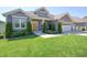 Charming single-story home with a well-manicured lawn and welcoming yellow front door at 1472 Maple Ridge Ct, Columbus, IN 47201