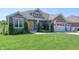Inviting single-story home with landscaped yard and a cozy front porch seating area at 1472 Maple Ridge Ct, Columbus, IN 47201