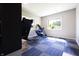 Bright gym area with workout equipment, large windows, and blue carpeting offering a healthy lifestyle space at 1472 Maple Ridge Ct, Columbus, IN 47201