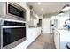 Contemporary kitchen featuring stainless steel appliances, white cabinets, and a stylish backsplash at 1472 Maple Ridge Ct, Columbus, IN 47201