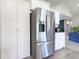 Modern kitchen with stainless steel appliances, white cabinets, and pantry storage at 1472 Maple Ridge Ct, Columbus, IN 47201