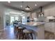 Open kitchen featuring a granite island with seating, modern appliances, and bright lighting at 1472 Maple Ridge Ct, Columbus, IN 47201