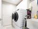 Modern laundry room with sleek appliances, ample storage, and a convenient utility sink at 1472 Maple Ridge Ct, Columbus, IN 47201