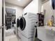 Efficient laundry room with modern appliances, storage cabinets, and easy access to other areas at 1472 Maple Ridge Ct, Columbus, IN 47201