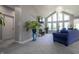 Bright living room featuring vaulted ceilings, large windows, gray walls, and a comfortable blue sofa at 1472 Maple Ridge Ct, Columbus, IN 47201