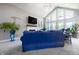 Open living area showcasing a fireplace, TV, vaulted ceilings, and a stylish blue sofa at 1472 Maple Ridge Ct, Columbus, IN 47201