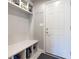 Functional mudroom with built-in bench, storage shelves, and convenient access to the home's interior at 1472 Maple Ridge Ct, Columbus, IN 47201