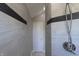 Modern walk-in shower with light gray tile and updated shower head fixture at 1472 Maple Ridge Ct, Columbus, IN 47201