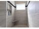Modern walk-in shower with light gray tile, shower niche, and a built-in seat at 1472 Maple Ridge Ct, Columbus, IN 47201