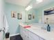 Bright bathroom with double vanity, quartz counters, decorative lighting, and tiled shower in background at 15143 Gallop Ln, Fishers, IN 46040