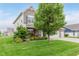 Charming two-story home featuring a brick facade, three-car garage, manicured lawn, and lush landscaping at 15143 Gallop Ln, Fishers, IN 46040