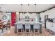 Well-appointed kitchen featuring white cabinetry, an island with bar seating, and a sliding barn door to dining area at 15143 Gallop Ln, Fishers, IN 46040