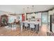 Open kitchen featuring granite countertops, an island with bar seating, and seamless connection to the dining area at 15143 Gallop Ln, Fishers, IN 46040