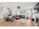 Spacious living room with fireplace, staircase, wood floors, and a comfortable seating arrangement at 15143 Gallop Ln, Fishers, IN 46040
