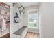 Convenient mudroom boasts stylish shiplap walls, bench with storage, and access to the pantry at 15143 Gallop Ln, Fishers, IN 46040