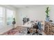 Bright home office featuring a large window, stylish rug, and versatile workstation for productivity at 15143 Gallop Ln, Fishers, IN 46040