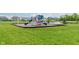 Well-maintained playground with slides and climbing structures in a grassy area at 15143 Gallop Ln, Fishers, IN 46040