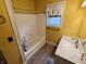 Bright bathroom with a shower-tub combination, marble vanity, and a window at 152 1St W St, Shelbyville, IN 46176