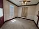 Vintage bedroom features a ceiling fan, carpeted floor, and natural light from a window, blending classic charm at 152 1St W St, Shelbyville, IN 46176