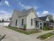Charming home showcasing an inviting exterior with vinyl siding and a well-maintained gray roof on a sunny day at 152 1St W St, Shelbyville, IN 46176