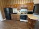 Kitchen featuring wood cabinets, modern appliances, and hardwood floors at 152 1St W St, Shelbyville, IN 46176