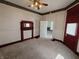 Traditional living room with ceiling fan, historic trim details, and natural light creates an inviting atmosphere at 152 1St W St, Shelbyville, IN 46176