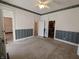 Spacious living room with doorways into other rooms, carpeted floor, and ceiling fan, perfect for entertaining or relaxing at 152 1St W St, Shelbyville, IN 46176