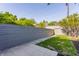 Well-maintained backyard featuring a gray privacy fence, patio, landscaping and a small lawn at 1520 Central Ave, Indianapolis, IN 46202