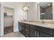 A modern bathroom features double sinks with gray cabinets and a walk-in closet for ample storage at 1520 Central Ave, Indianapolis, IN 46202