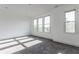 Bright bedroom filled with natural light from large windows, plush carpet, and clean white walls at 1520 Central Ave, Indianapolis, IN 46202