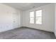 Bedroom with neutral carpet, white walls, natural light, and minimal design create a clean space at 1520 Central Ave, Indianapolis, IN 46202