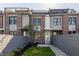Attractive townhome featuring a well-kept lawn, gray fence, and stone pathway to the front door at 1520 Central Ave, Indianapolis, IN 46202