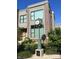 Attractive townhome featuring brick facade, large windows, and manicured landscaping, located near a vintage clock at 1520 Central Ave, Indianapolis, IN 46202