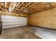 Unfinished garage with concrete floor, wood framing, plywood walls, and a white door at 1520 Central Ave, Indianapolis, IN 46202