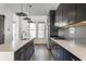 Well-appointed kitchen with quartz countertops, stainless steel appliances, and black modern cabinetry at 1520 Central Ave, Indianapolis, IN 46202