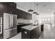 A modern kitchen featuring stainless steel appliances, quartz countertops, and dark contemporary cabinetry at 1520 Central Ave, Indianapolis, IN 46202
