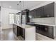 Stylish kitchen with black cabinets, stainless steel appliances, and a quartz countertop island at 1520 Central Ave, Indianapolis, IN 46202