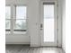 Bright living room featuring a glass patio door, large windows, and stylish gray-toned flooring at 1520 Central Ave, Indianapolis, IN 46202