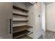 A convenient walk-in pantry features custom wood shelving and sleek sliding door in a modern home at 1520 Central Ave, Indianapolis, IN 46202