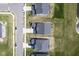 Overhead aerial view of multiple residences showing a pond, manicured lawns, and driveways at 15413 Staffordshire Way, Fishers, IN 46037