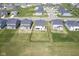 Aerial view of home with fenced backyard featuring green lawn and outdoor patio space at 15413 Staffordshire Way, Fishers, IN 46037