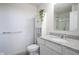 White bathroom featuring a toilet, sink with granite countertop, and a storage cabinet with shelving at 15413 Staffordshire Way, Fishers, IN 46037