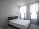 Bedroom featuring carpet, a queen sized bed, and natural light from windows with gray curtains at 15413 Staffordshire Way, Fishers, IN 46037