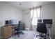 Office bedroom featuring carpet, two desks, and natural light streaming through a large window at 15413 Staffordshire Way, Fishers, IN 46037