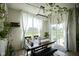 Charming dining area with a chandelier, large windows overlooking the backyard and stylish decor at 15413 Staffordshire Way, Fishers, IN 46037